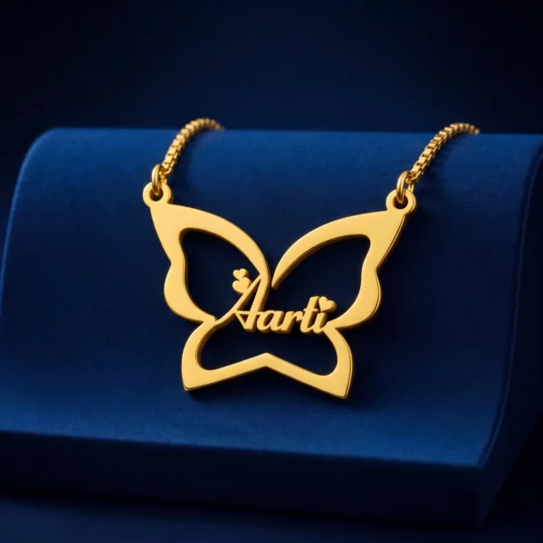 Gold-tone large butterfly outline name necklace on a navy velvet display