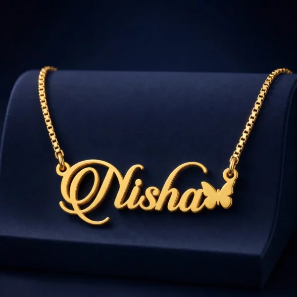 Gold-tone script name necklace with a small butterfly on a navy velvet display