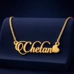 Gold-tone decorative script name necklace with a heart on a navy velvet display