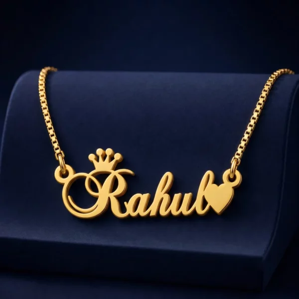 Gold-tone crown and heart name necklace on a navy velvet display