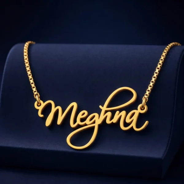 Gold-tone curved cursive name necklace on a navy velvet display