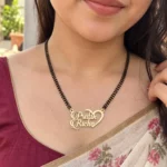 Half Heart Couple Name Necklace with a black-beaded chain worn with a sari