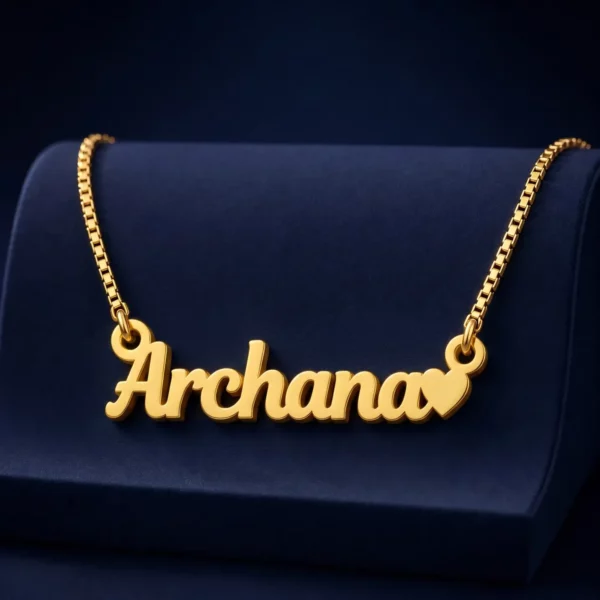 Gold-tone simple name pendant with a small heart on a navy velvet display
