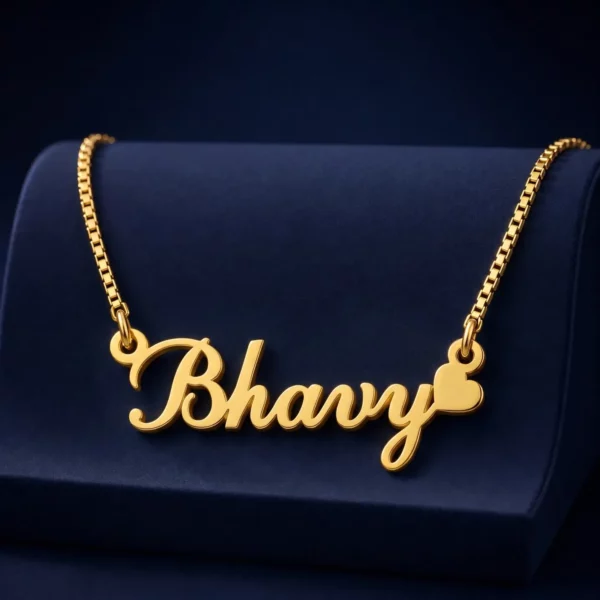 Gold-tone curved script name necklace with a heart on a navy velvet display