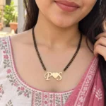 Heart Initials Couple Necklace with a black-beaded chain shown on a model