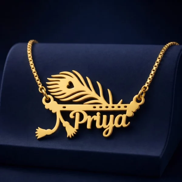 Gold-tone peacock feather and flute name pendant on a navy velvet display