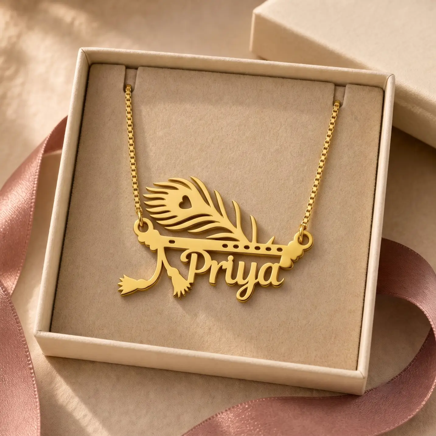 Mor Pankh Personalized Name Pendant - Jewellery Box Gold-tone peacock feather and flute name pendant displayed in an open beige jewellery box