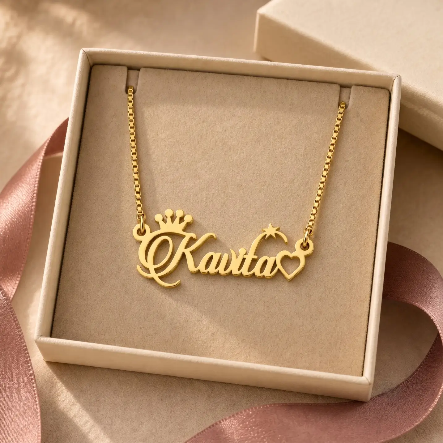 Crown, Star and Heart Name Necklace - Jewellery Box Gold-tone name necklace with crown, star and heart accents displayed in an open beige jewellery box