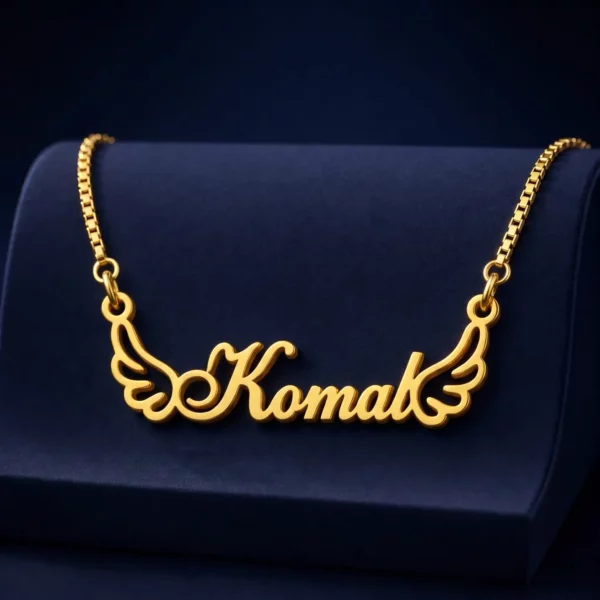 Gold-tone angel wings name necklace on a navy velvet display