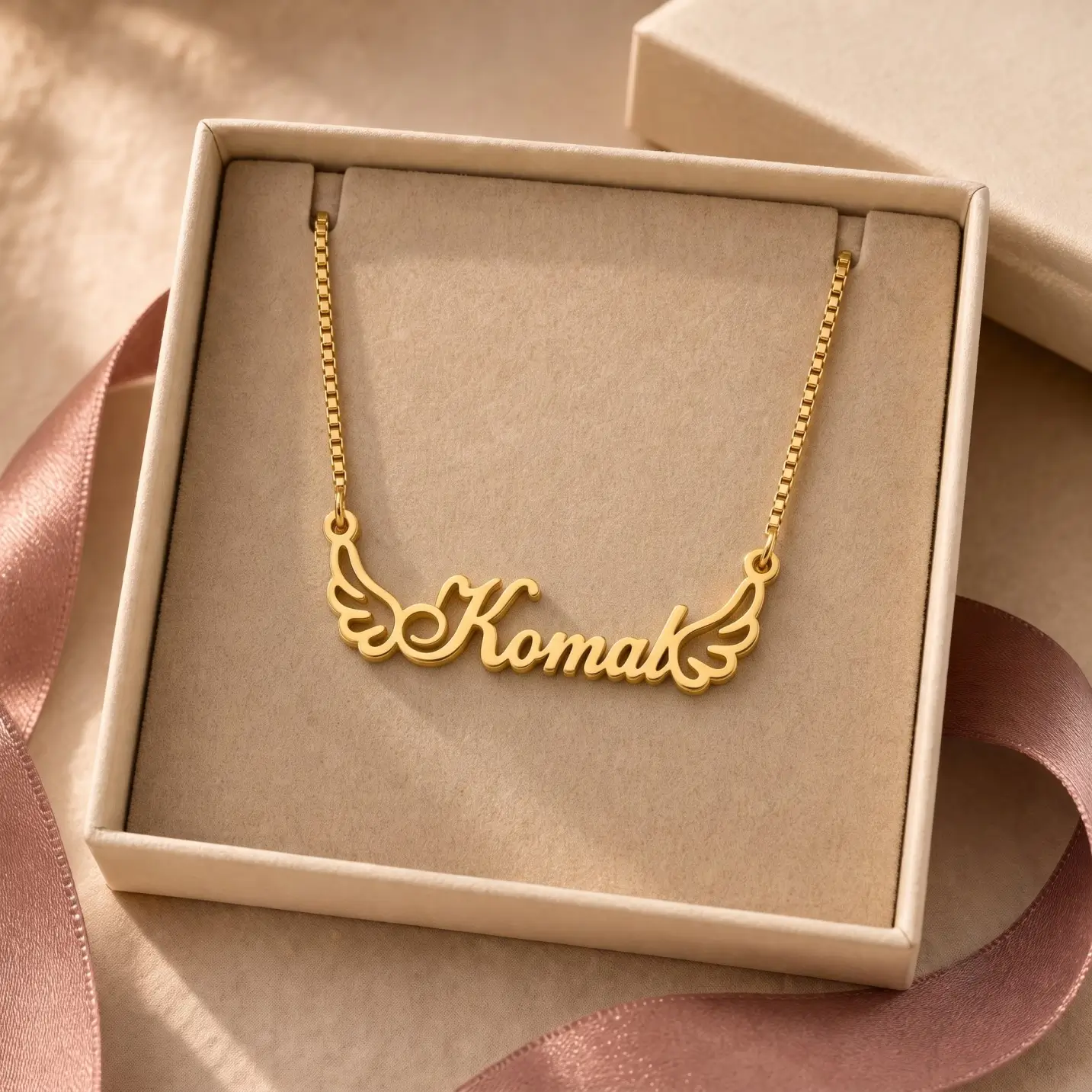 Angel Wings Name Necklace - Jewellery Box Gold-tone angel wings name necklace displayed in an open beige jewellery box