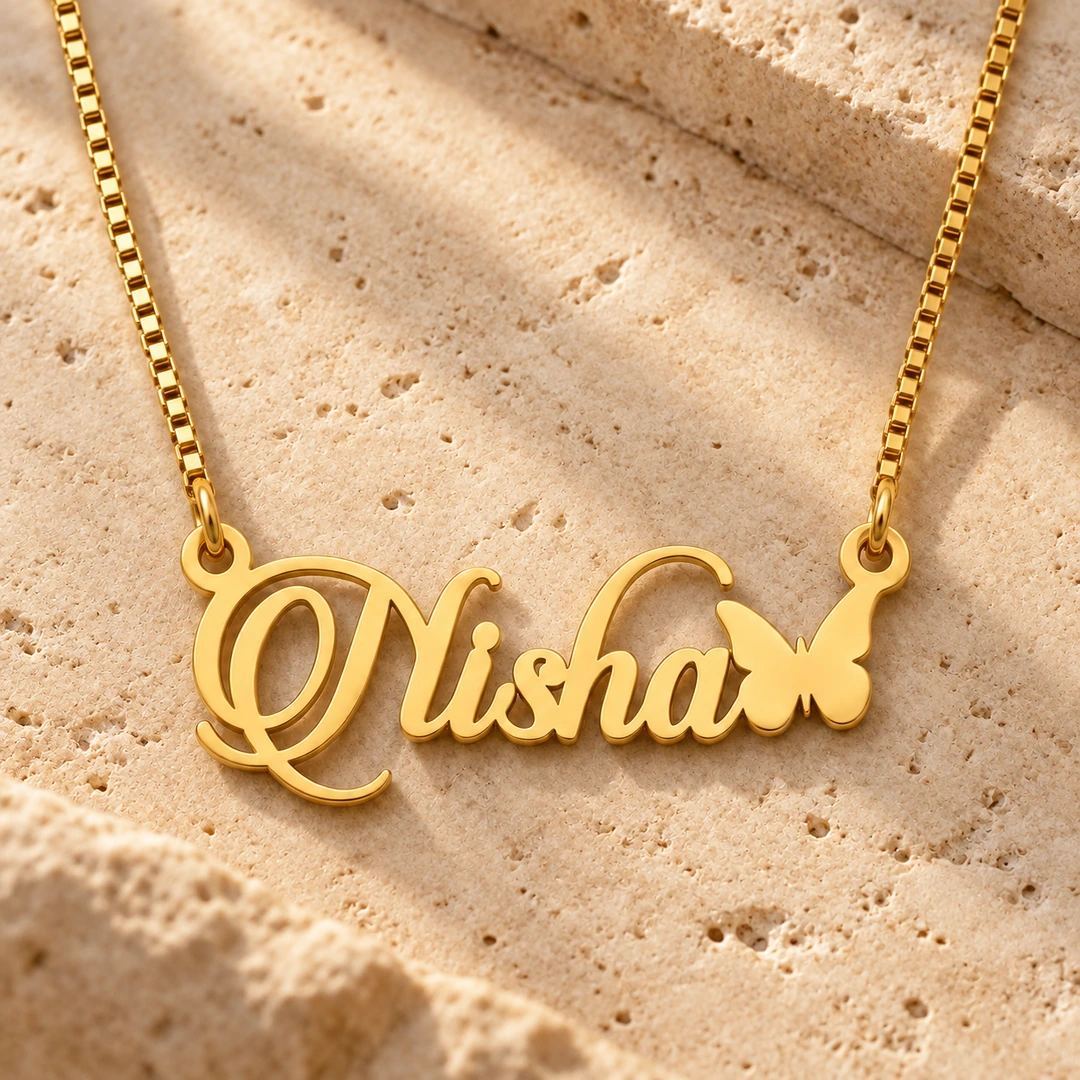 Butterfly Style Name Necklace Travertine Gold Nisha butterfly name necklace on warm textured stone