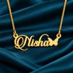 Gold Nisha ornate script name pendant with butterfly and golden box chain, teal satin product view