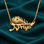 Gold Priya name pendant with peacock feather and flute design, golden box chain, teal satin product view