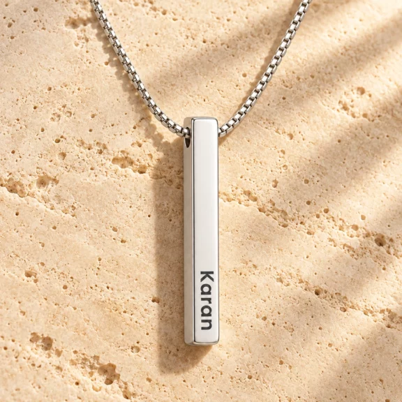 Personalized Silver Finish 3D Bar Pendant on a rough stone surface