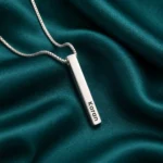 Personalized Silver Finish 3D Bar Pendant on dark green fabric