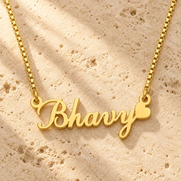 Curved Heart Name Necklace on a rough stone surface