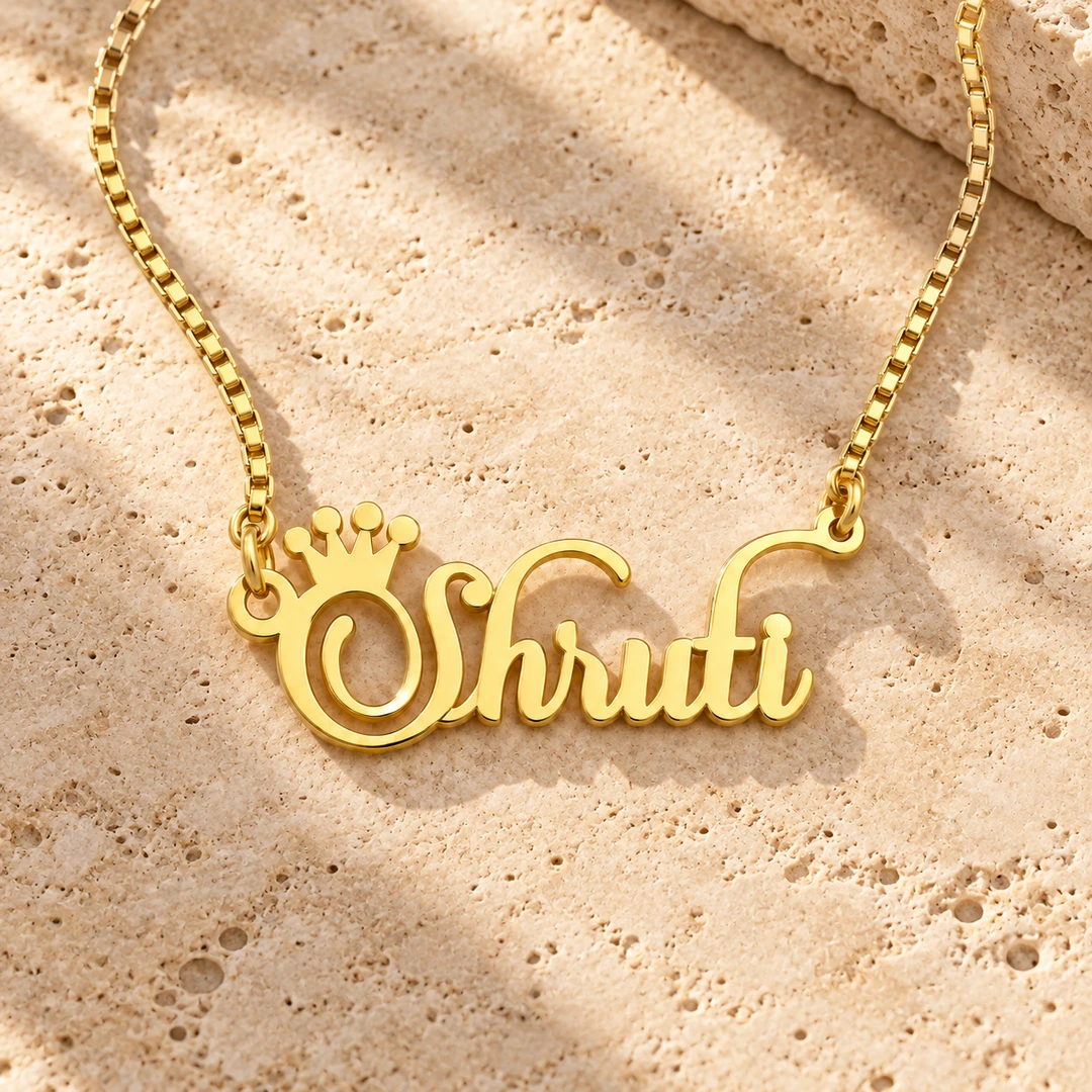 Crown Name Necklace - Travertine Hero Crown Name Necklace with original gold box chain on travertine hero background