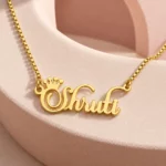Crown Name Necklace with original gold box chain on ceramic detail background