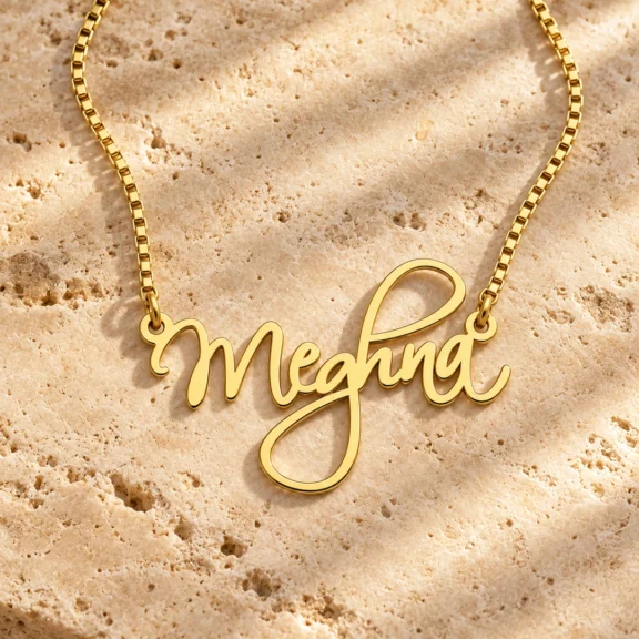 Curved Letter Name Necklace on a rough stone surface