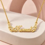 Angel Wings Name Necklace on a pink display