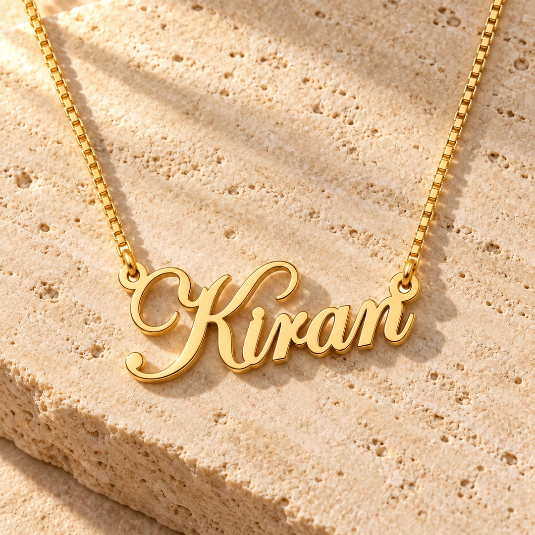 Stylish Name Pendant — Travertine concept Gold Kiran stylish name pendant and box chain on travertine stone