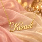 Gold Kiran stylish name pendant and box chain on blush organza