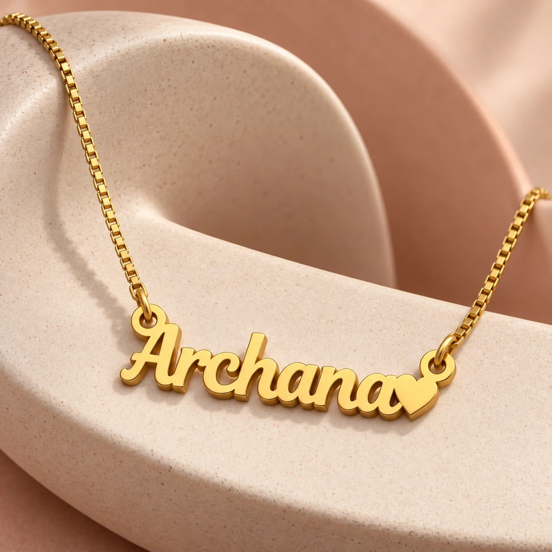 Heart Name Pendant — Ceramic concept Gold Archana name pendant with solid heart and box chain on curved ceramic