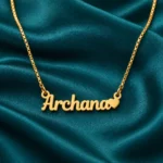 Gold Archana name pendant with solid heart and original box chain, teal setting