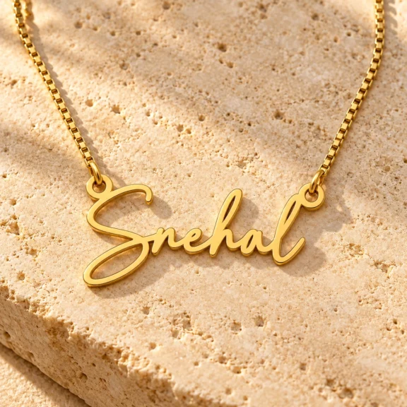 Signature Name Necklace on a rough stone surface