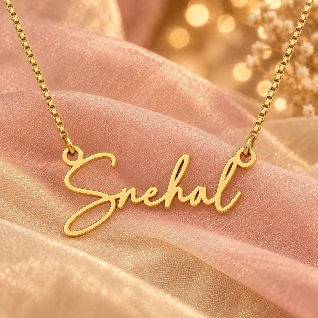Signature Style Name Necklace — Blush organza concept Gold Snehal signature name pendant and box chain on blush organza