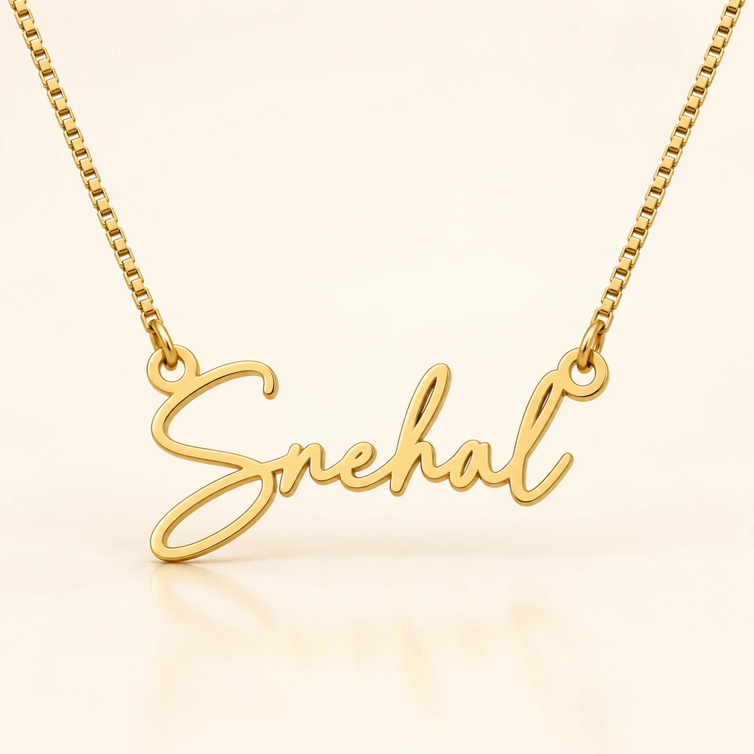 Signature Style Name Necklace — Clean ivory catalog image Gold Snehal signature style name necklace with box chain on ivory background