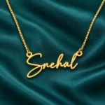 Gold Snehal signature style name necklace with original box chain, teal setting