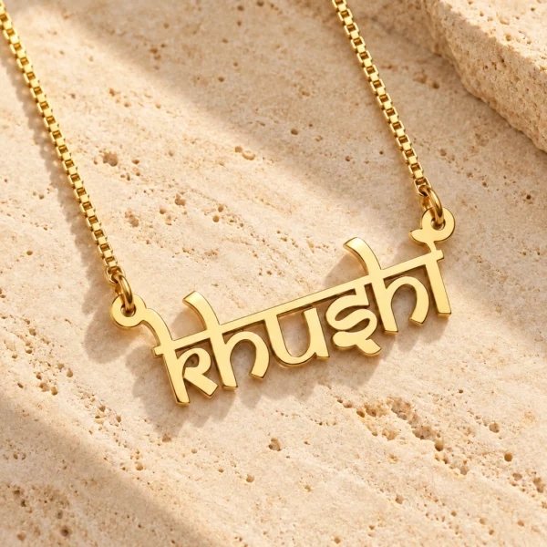 Indic Style Name Necklace necklace on travertine stone surface