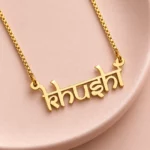 Indian Style Name Necklace on a pink display