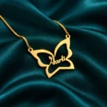 Gold butterfly outline Aarti name necklace with box chain, teal satin