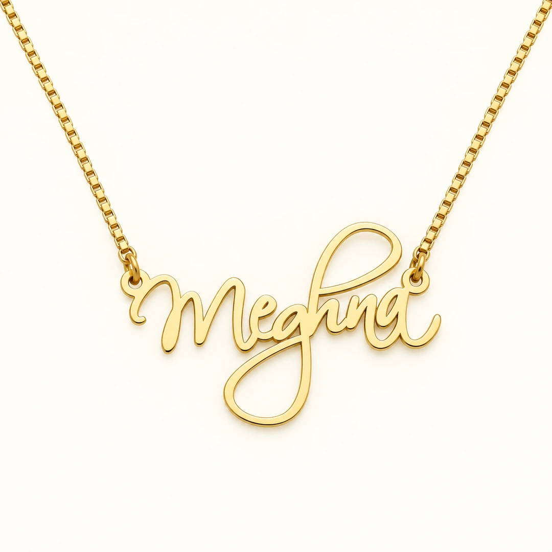 Cursive Curved Name Necklace - Clean Ivory Gold cursive Meghna name necklace with box chain on ivory background