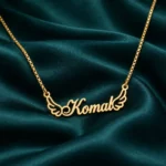 Angel Wings Name Necklace on dark green fabric