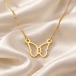 Butterfly Shape Letter Pendant with a chain on cream fabric