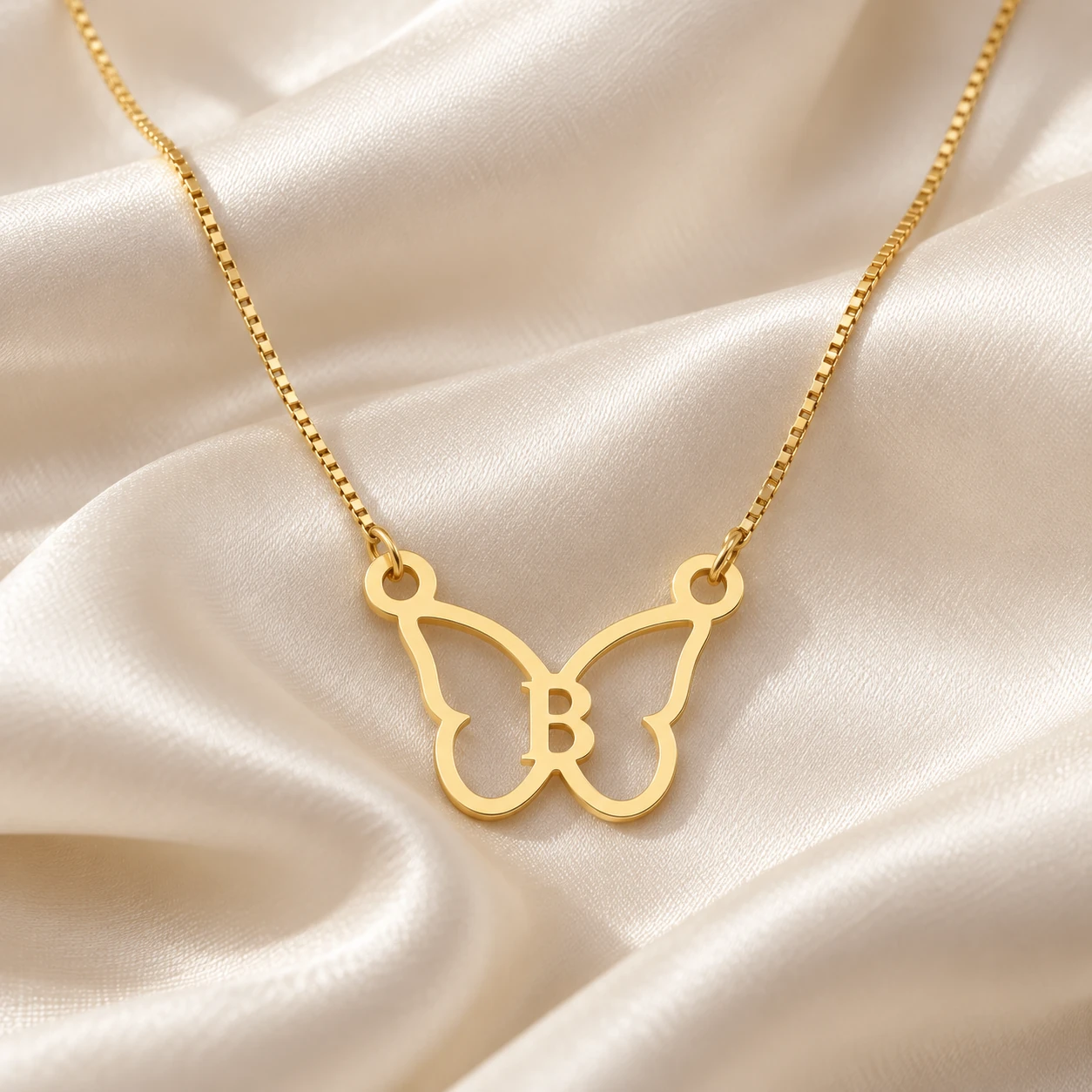 Butterfly Shape Letter Pendant - With a chain on cream fabric Butterfly Shape Letter Pendant with a chain on cream fabric