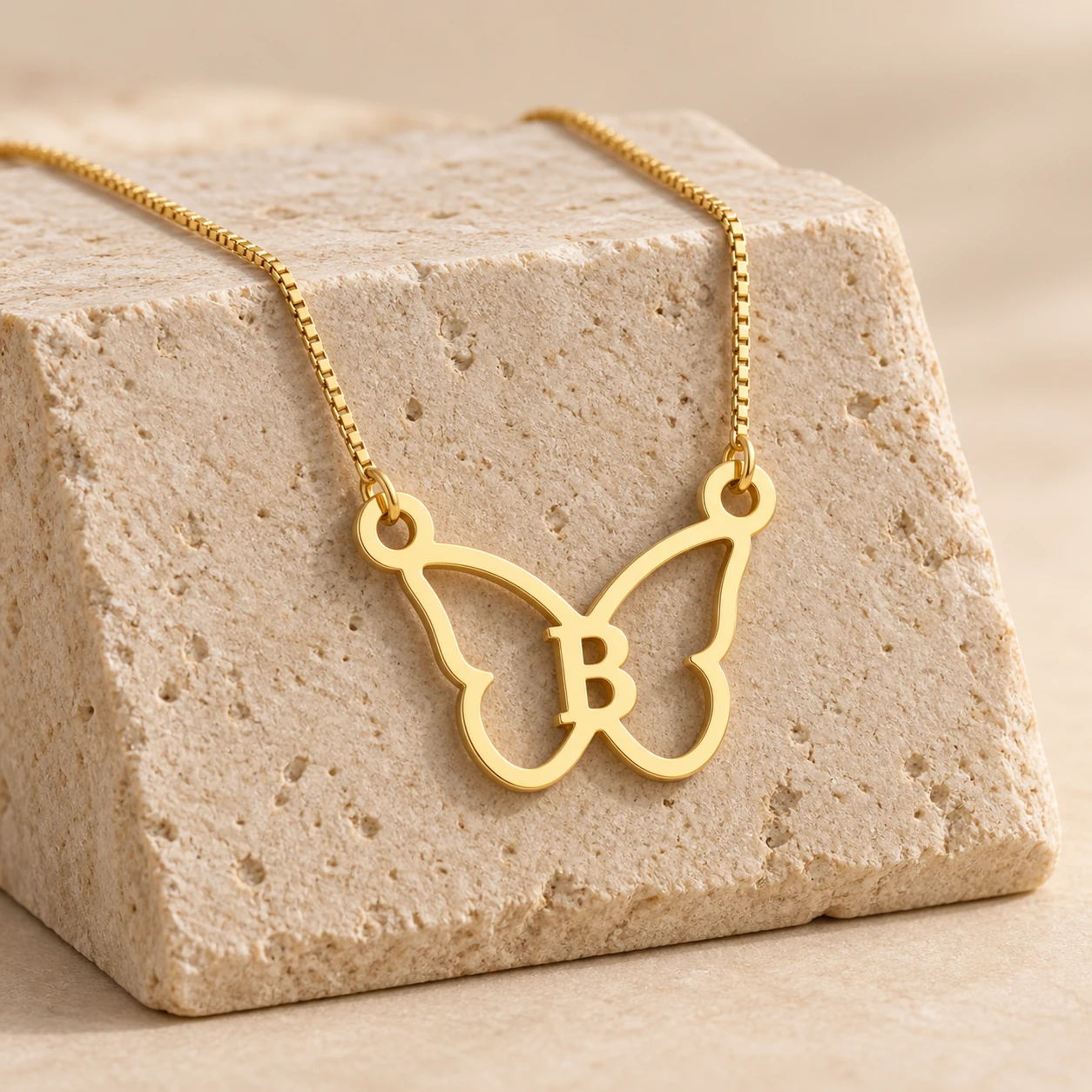 Butterfly Shape Letter Pendant - With a chain on a stone display Butterfly Shape Letter Pendant with a chain on a stone display