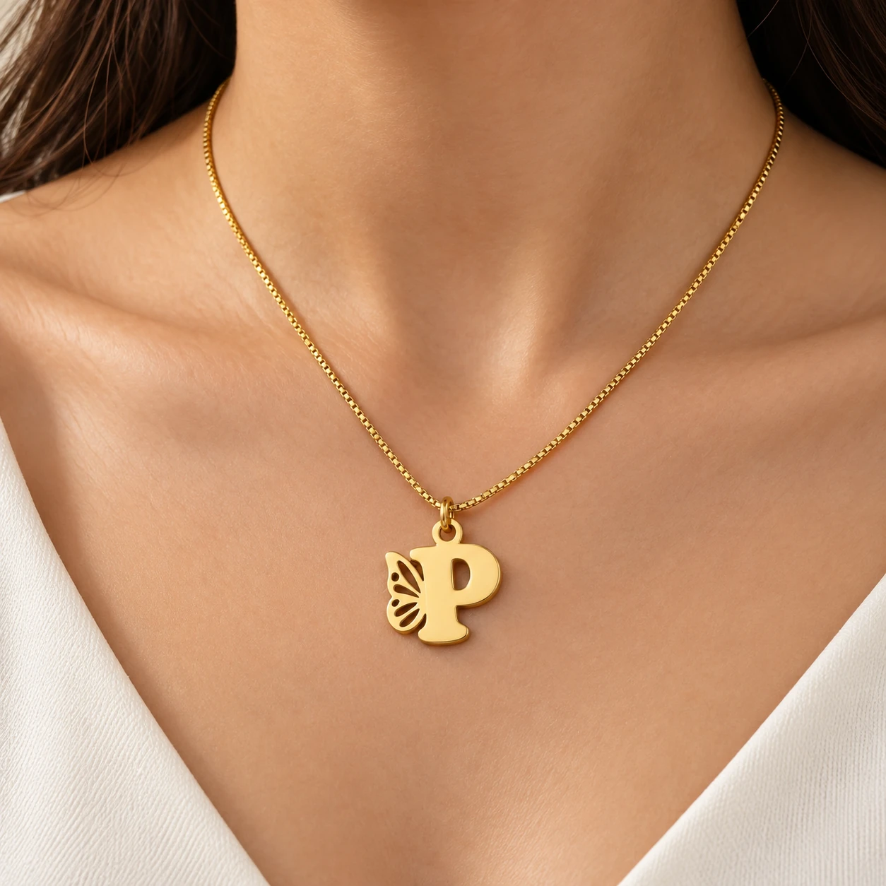 Butterfly P Letter Pendant - model-worn Gold P letter pendant with openwork butterfly wing and fine box chain - model-worn