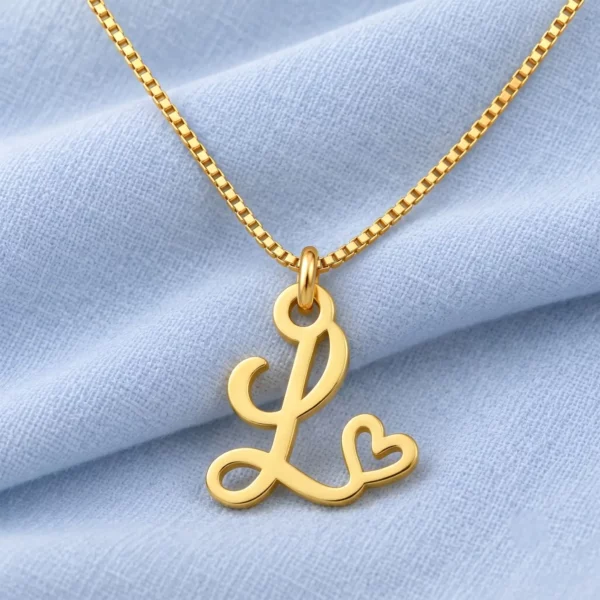 Curved Heart Letter Pendant displayed on pale blue fabric