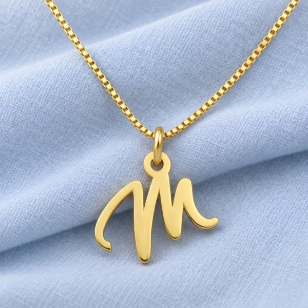 Handwritten Letter Pendant displayed on pale blue fabric