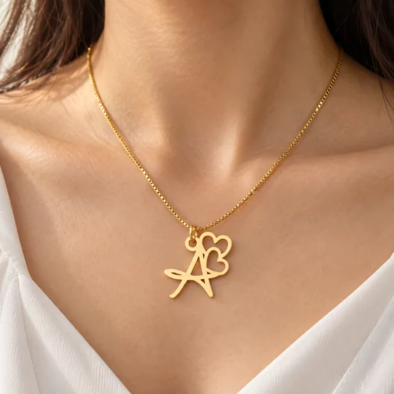 Double Heart Letter Pendant worn on a fine chain