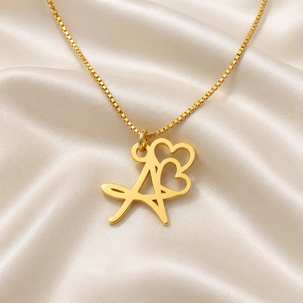 Double Heart Letter Pendant - With a chain on cream fabric Double Heart Letter Pendant with a chain on cream fabric