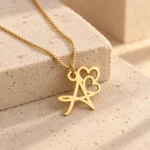 Double Heart Letter Pendant with a chain on a stone display