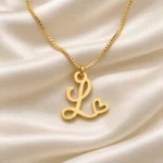 Curved Heart Letter Pendant with a chain on cream fabric