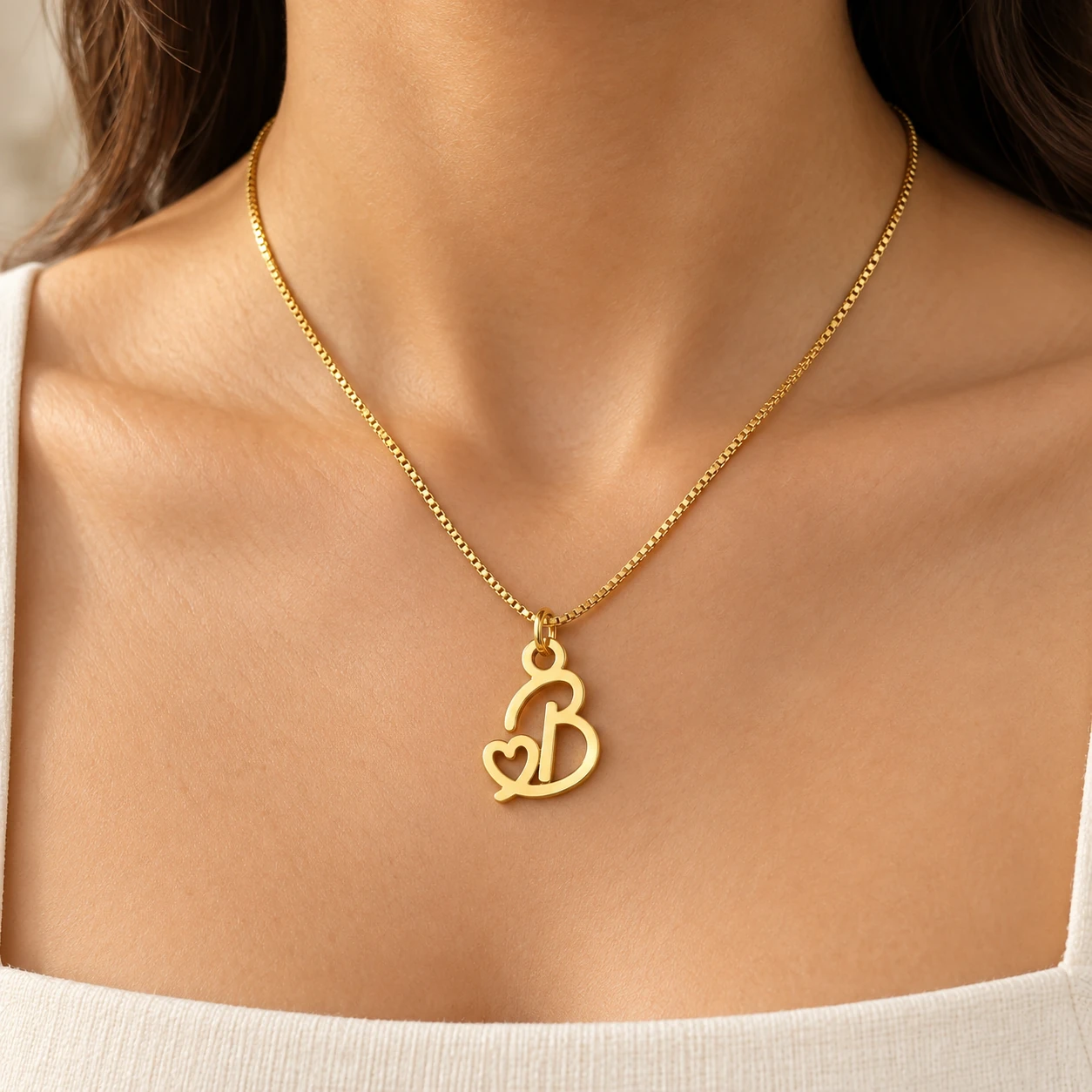 Heart Letter Pendant - model worn Gold B letter pendant with integrated heart cutout and fine box chain, model worn