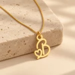 Gold B letter pendant with integrated heart cutout and fine box chain, stone