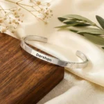 Personalized Silver Finish Adjustable Name Kada on a light display cushion